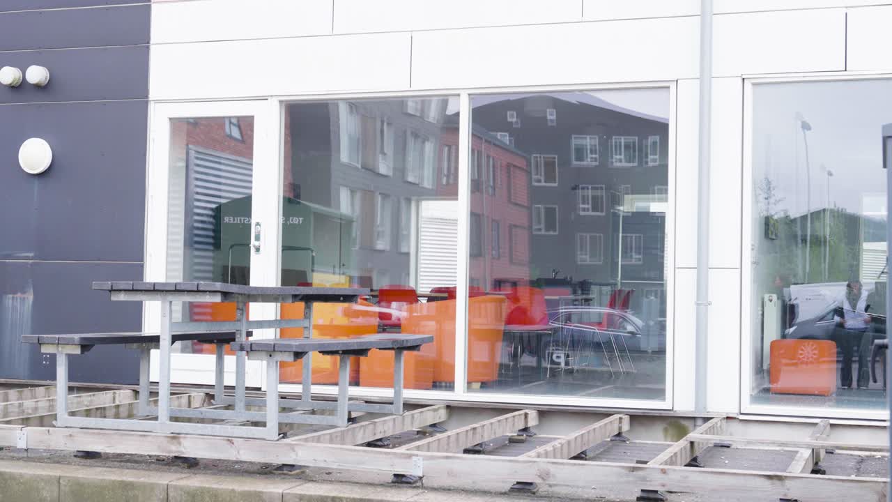 Construction of wooden outdoor terrace near building windows, Denmark