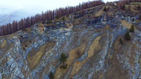 Drone-view-of-stunning-rock-cliff-views-of-the-hills-in-Busca,-Italy