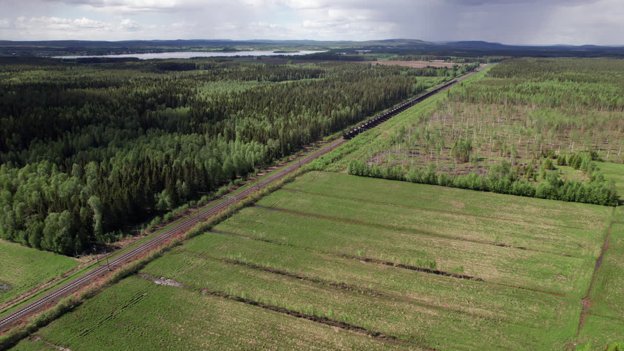 Drone View of Empty Swedish Freight Train, Cargo, Scandinavia, Kiruna, Luleå, Forest Landscape, Pull out,