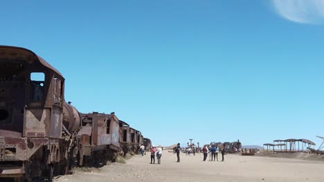 mix of rusty old trains in dessert with a vivid, blue skyline