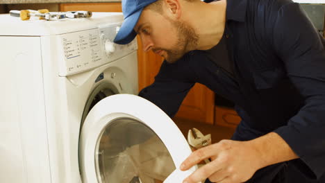 Man-fixing-the-washing-machine