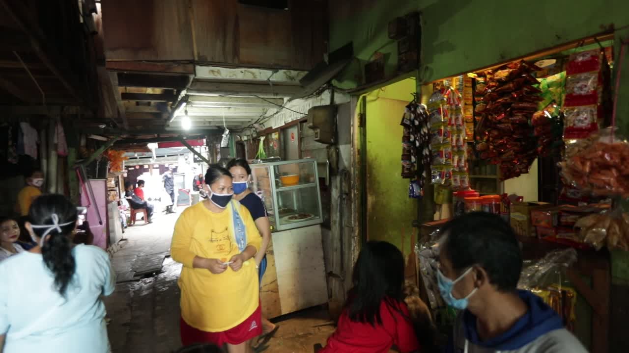 Transactions at small kiosks or "Warungs" in Indonesia. Small kiosks are common in Indonesia and are needed by local people to buy snacks, water and daily life consumption.