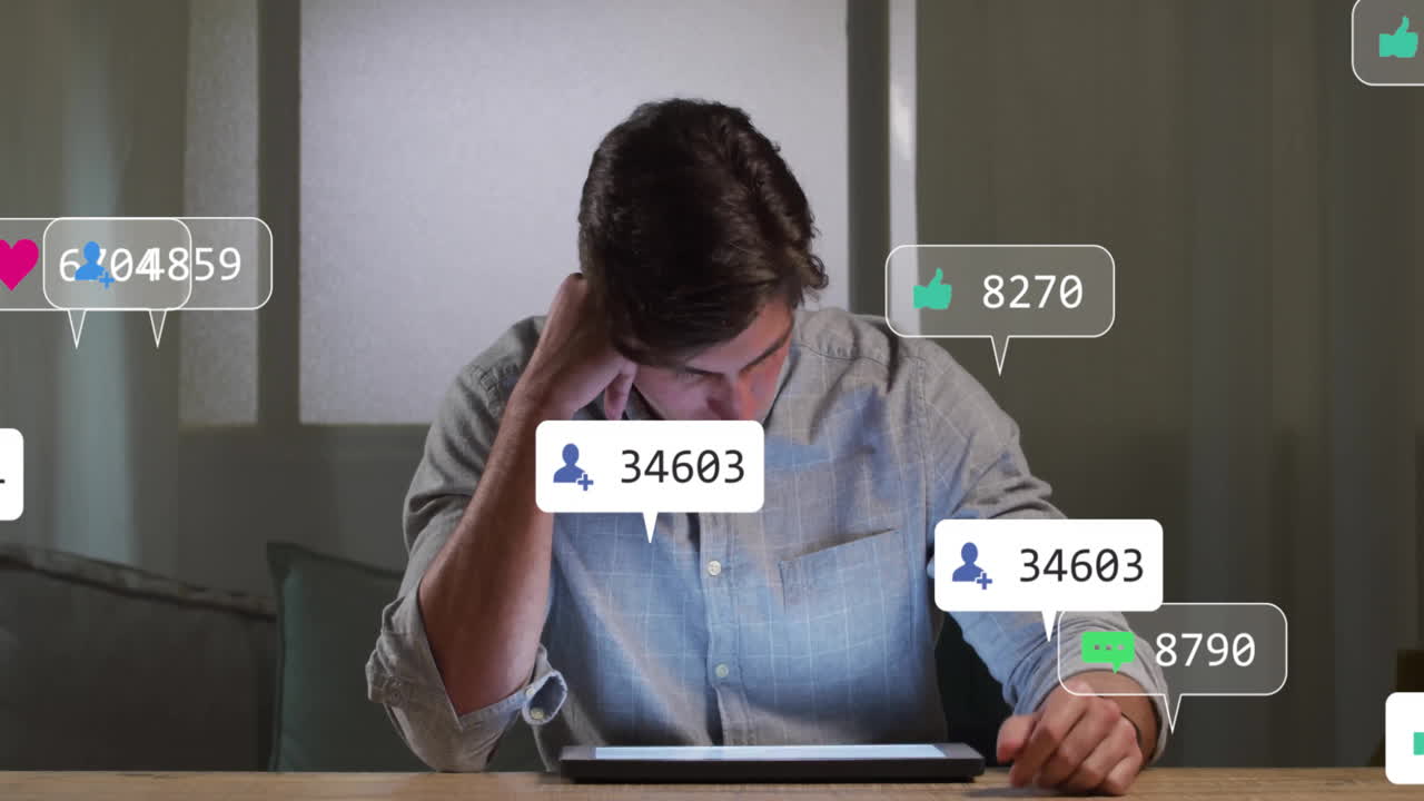 Man leaning at table tapping tablet screen with floating social notification icons for business