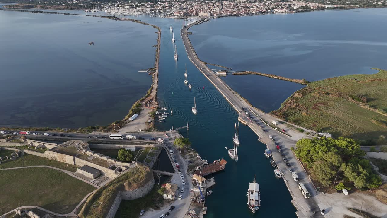Lefkas Channel,Wide Shot,Aerial view backwards slowly,all types for boats moving in the channel on a sunny day