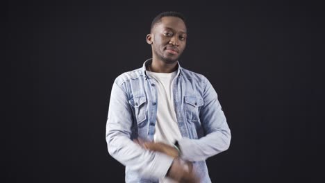 Stylish-and-handsome-African-young-man-with-folded-arms-looking-at-camera-freely-and-confidently.