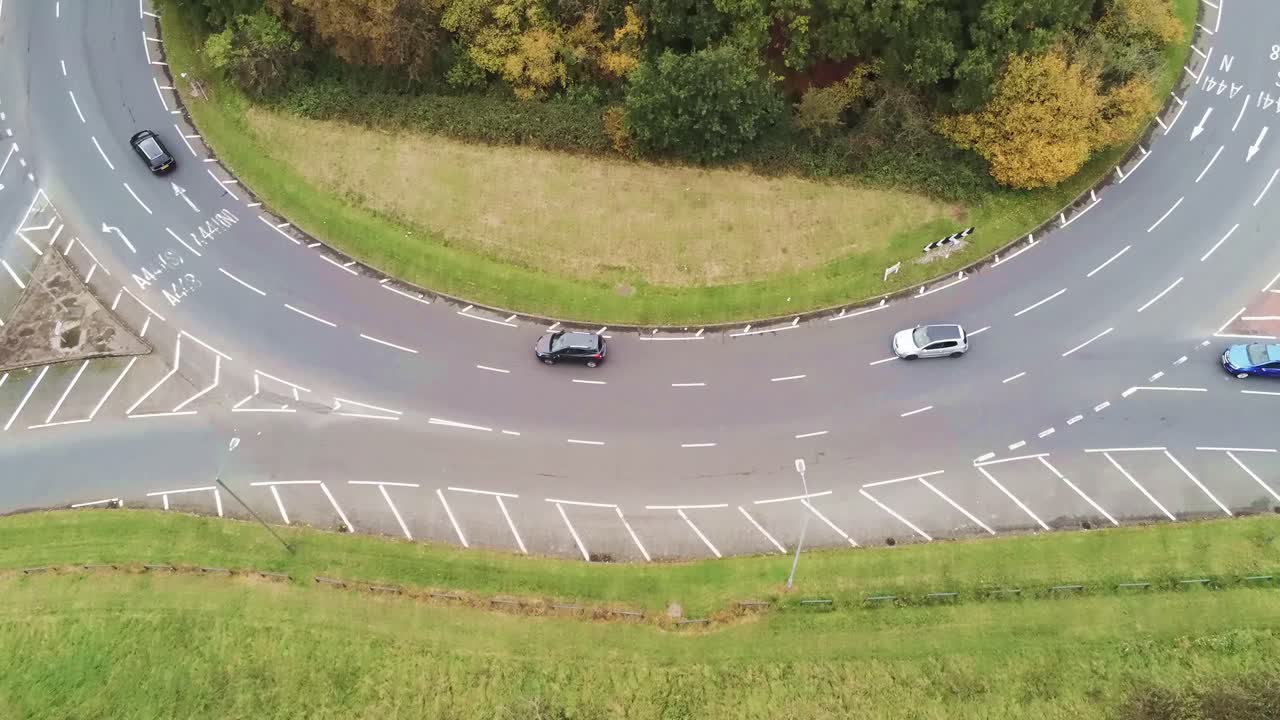 Roundabout roads junction fly over aerial view looking down at suburb neighbourhood