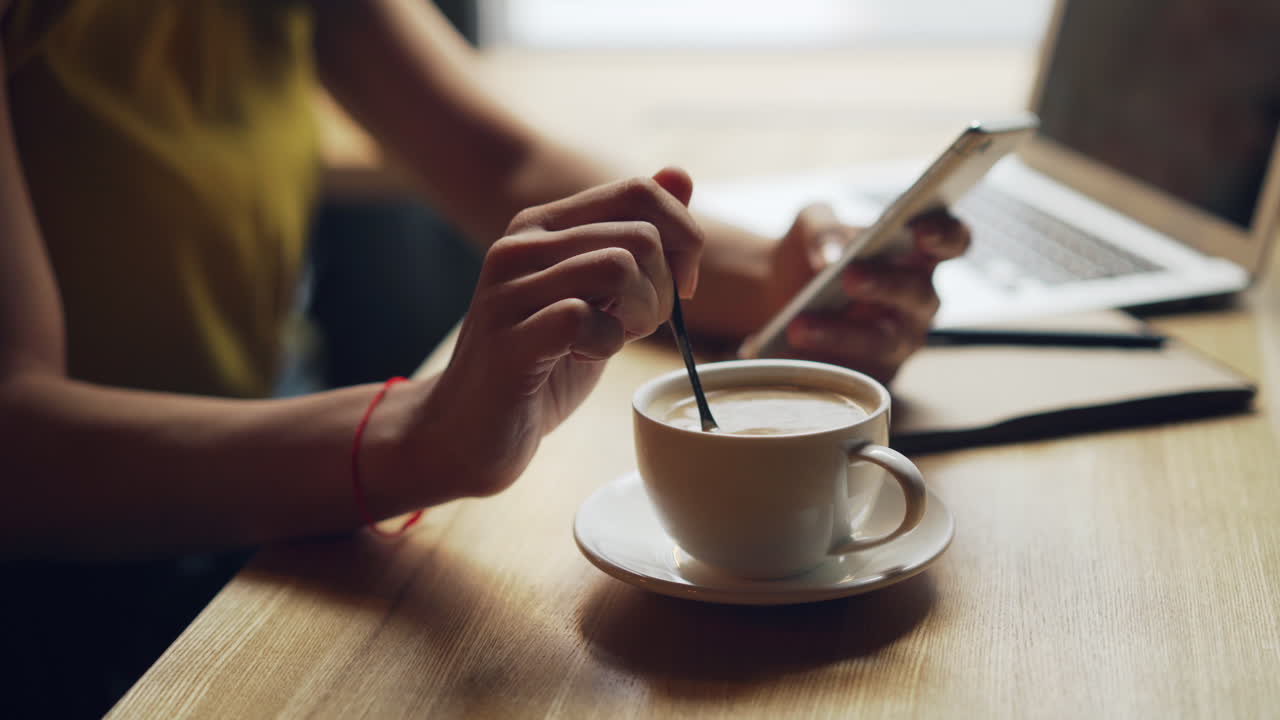 Woman working in a cafe with coffee and laptop