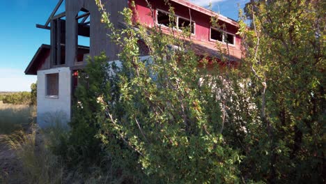 Tilting-up-shot-of-a-dilapidated-desert-barn-in-ruins