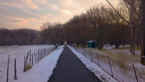 Running,-walking-or-biking-along-a-rural-path-in-the-winter---point-of-view---can-be-sped-up,-slowed-down-or-reversed-for-many-uses