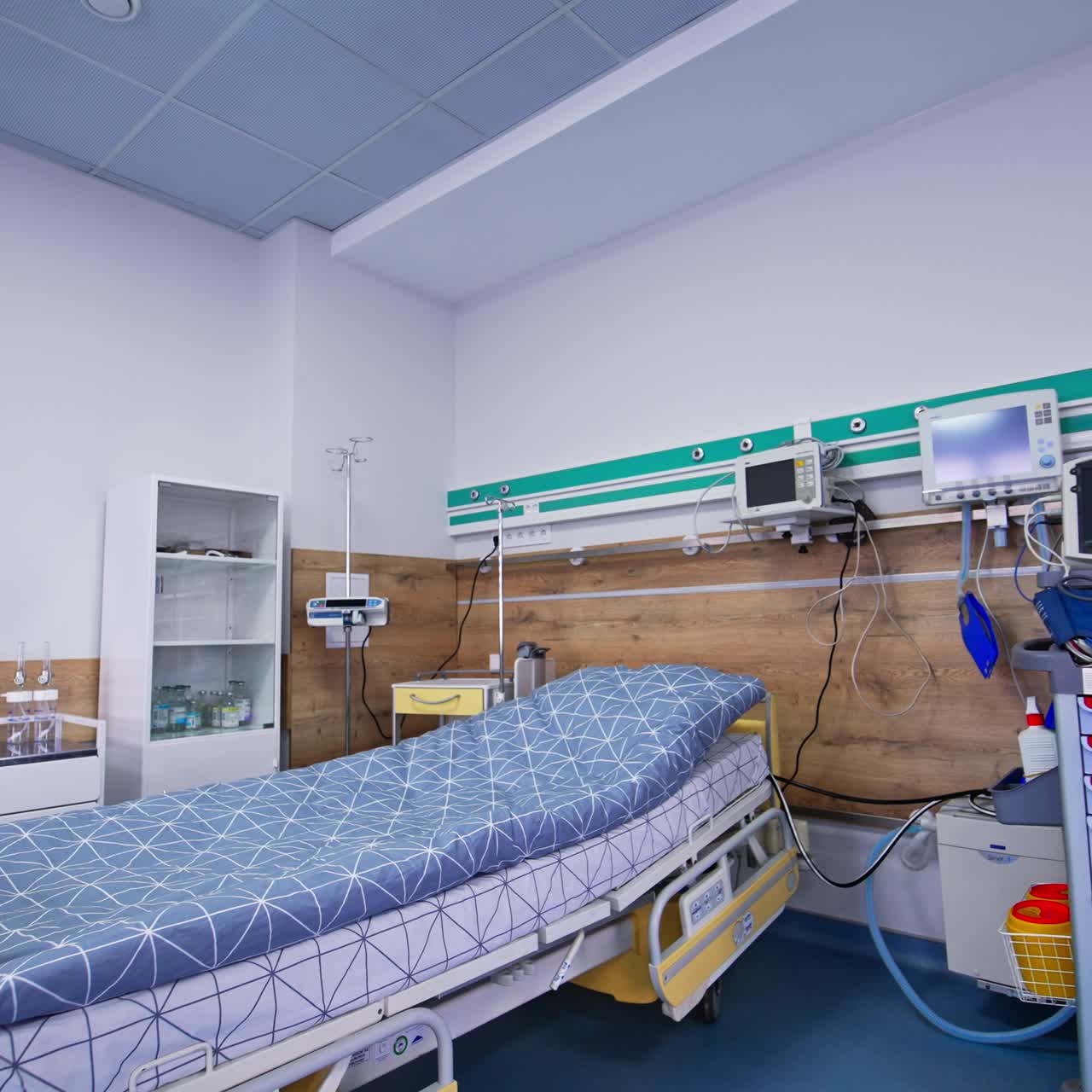 Multiple monitors hanging over the beds in intensive care unit. Modernly equipped ward for hard patients