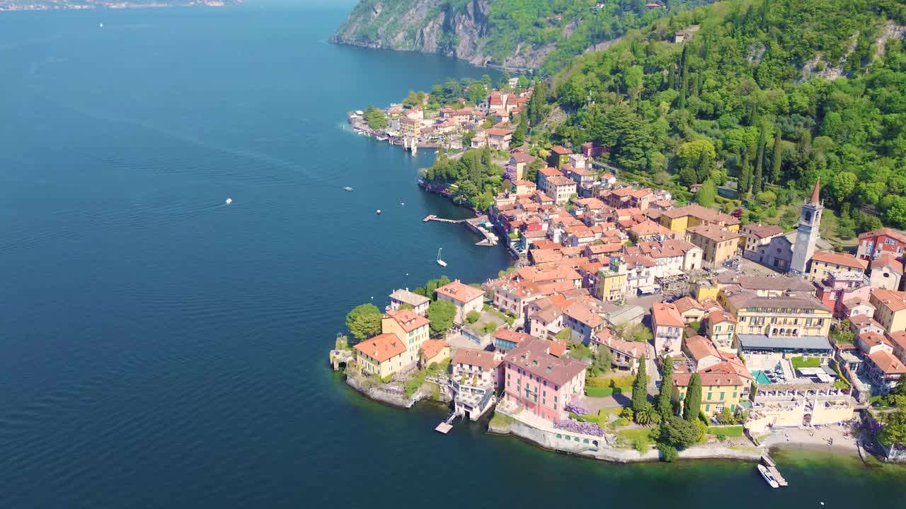 Vista aerea con drone delle case colorate di Varenna sulla costa del Lago di Como, pittoresco villaggio italiano sull'acqua, destinazione di viaggio Italia
