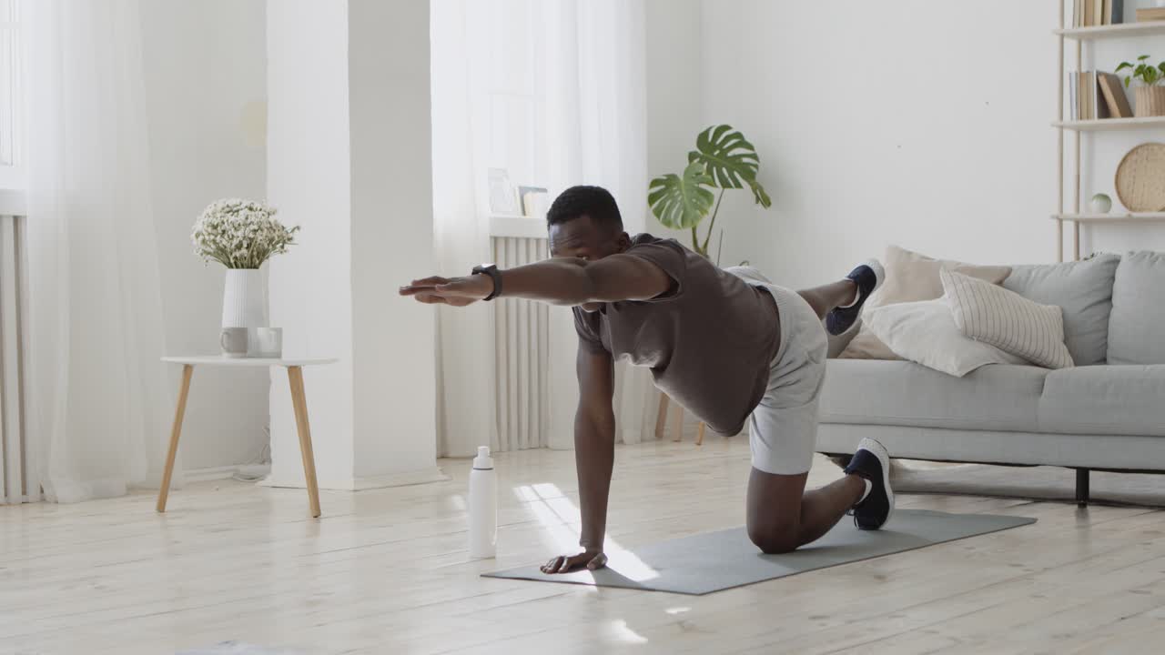 Man doing yoga exercises at home