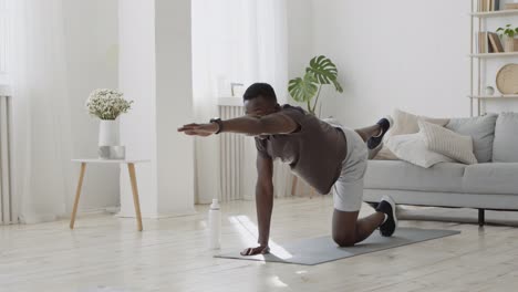 man doing yoga exercises at home