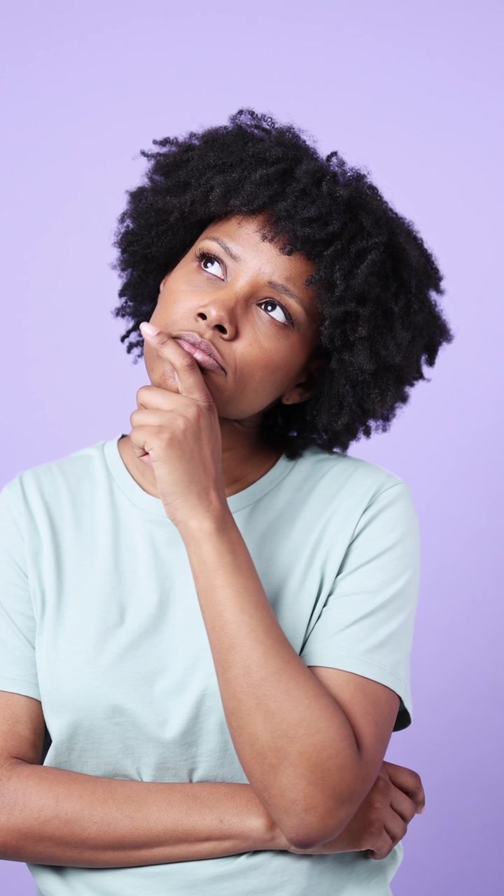 Thoughtful Young Black Woman Pondering with Hand on Chin