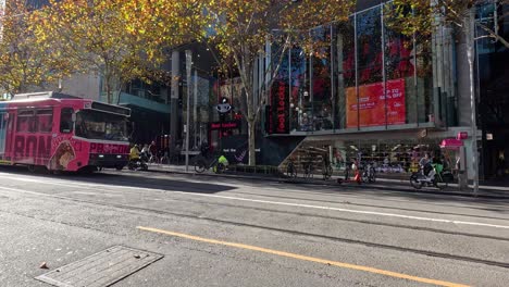 a tram moves along swanston street in melbourne