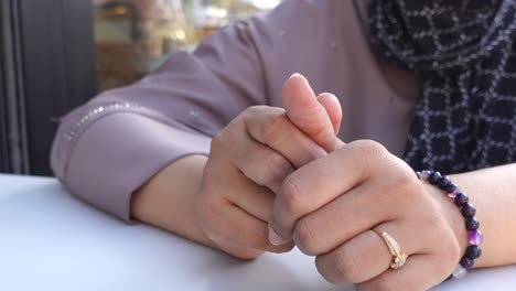 close-up of a woman's hands with jewelry