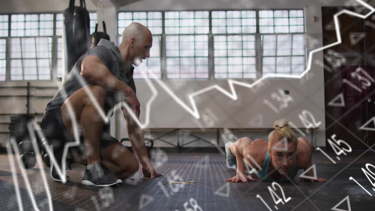 Coach kneeling pointing to marker in gym, client doing push-ups, animated charts tracking fitness