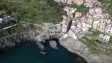 Manarola-Cinque-Terre-Italy-aerial-overhead-busy-tourist-area-along-water