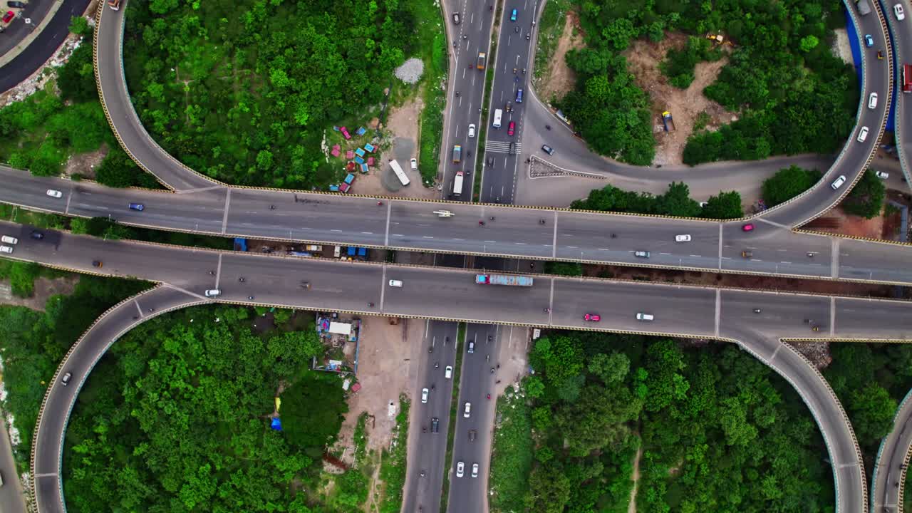 spectacular top down view of maduravoyal flower shaped bypass flyover with vehicles and greenery at Kamaraj Nagar, Chennai Bypass Road, Tamil Nadu, india. day time, top down shot, drone shot, 4k.