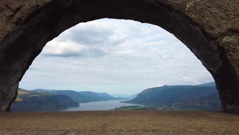 4k nice static view of the columbia river through an archway with mostly cloudy sky