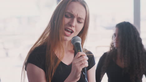 Estudiante-De-Canto-Femenino-En-La-Escuela-De-Artes-Escénicas-Cantando-Con-La-Banda-En-El-Ensayo