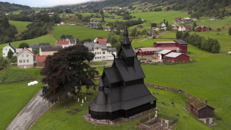 black stave church in a countryside village of norway