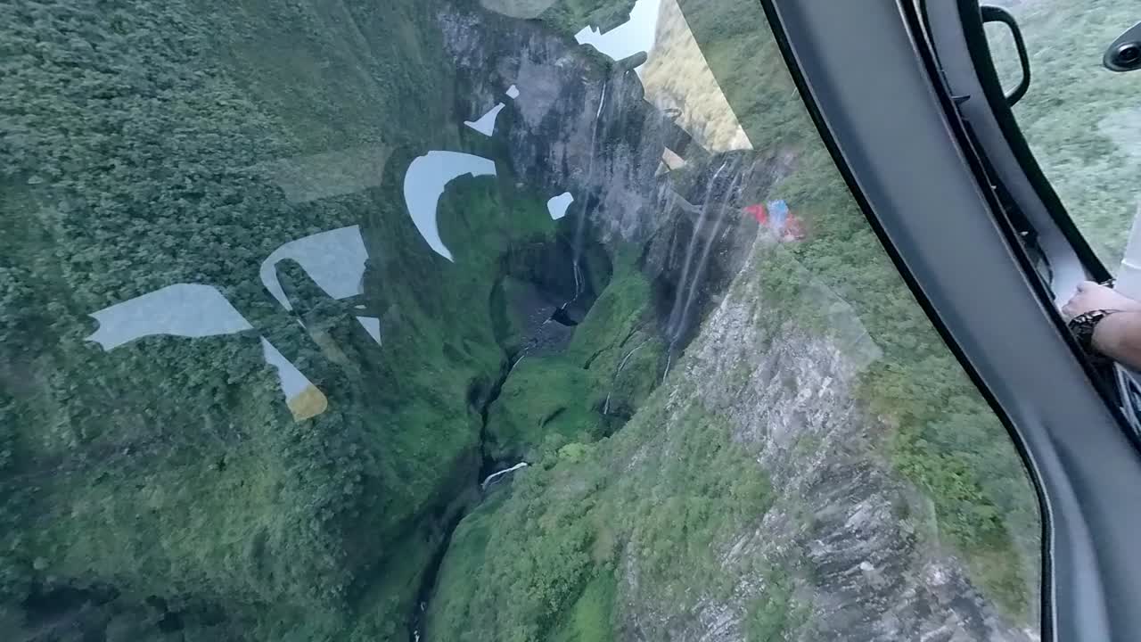 A stunning aerial view from a helicopter over The Cirque of Mafate, revealing breathtaking waterfalls deep within the dramatic landscapes of Reunion Island.