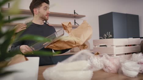 busy caucasian couple unpacking some kitchen stuff in new house.