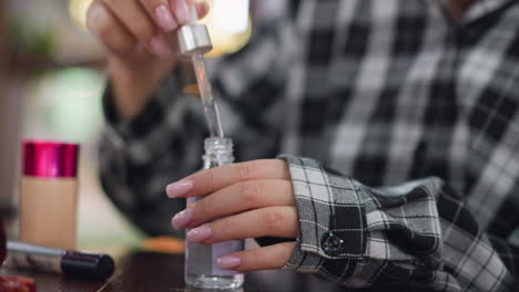 closeup view of young lady opening a facial supplement bottle on a wooden table, her manicured hands carefully handle the skincare product, surrounded by beauty essentials in a stylish setting