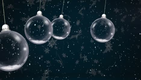 Animation-of-christmas-baubles-dangling-over-snow-falling-on-black-background