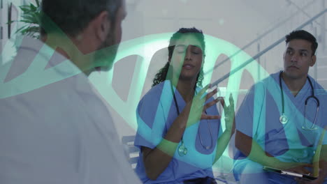 medical team in blue scrubs discussing case in clinic area, displaying animated dna double helix