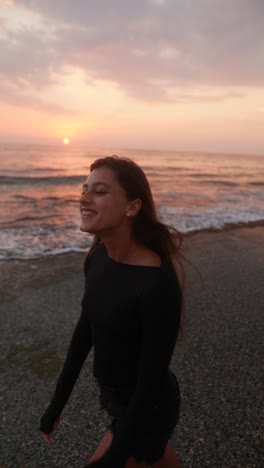 woman walking on the beach at sunset