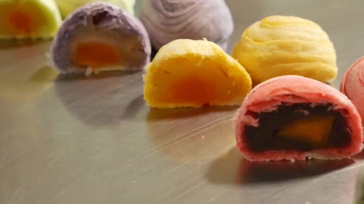 Different Color of Chinese Pastry Cut in Half Showing Its Stuffing, Close Up