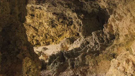 Panning-slowly-across-Ghar-Lapsi-cave-with-natural-rocky-hole-in-Malta