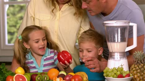 smiling family preparing smoothie