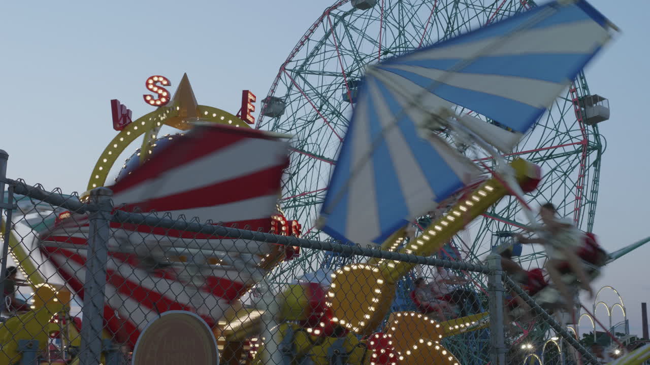 Summer in Brooklyn's Coney Island at the famous boardwalk and amusement park along the Atlantic Ocean. Wonder Wheel turning in the background.