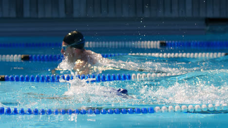 Man-and-woman-swimming-together-inside-the-pool-4k