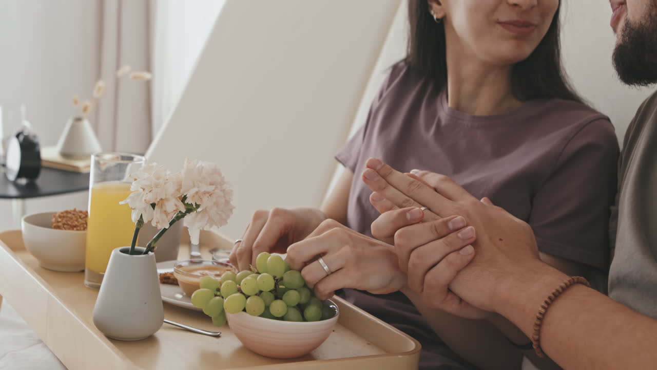 Young Married Couple Having Breakfast In Bed
