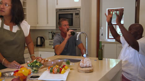 in kitchen, senior diverse women preparing vegetables, sharing conversation and laughter, at home
