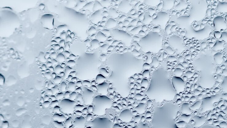 Raindrops on the window. Rainy weather. Blue tone