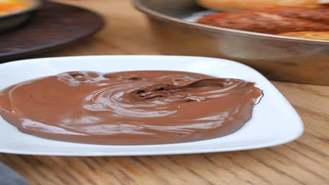 close-up of creamy chocolate spread on white dish