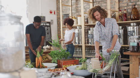 shoppers buying fresh fruit and vegetables in sustainable plastic free grocery store