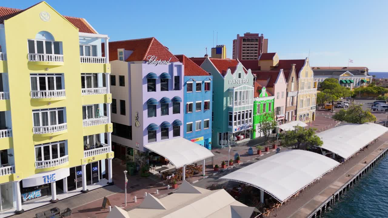 Aerial angled dolly along the historic buildings in Punda District, Willemstad, Curacao, a UNESCO site