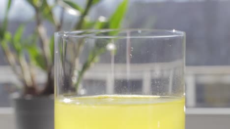 vitamin c tablet is buzzing over yellow healthy drink water level