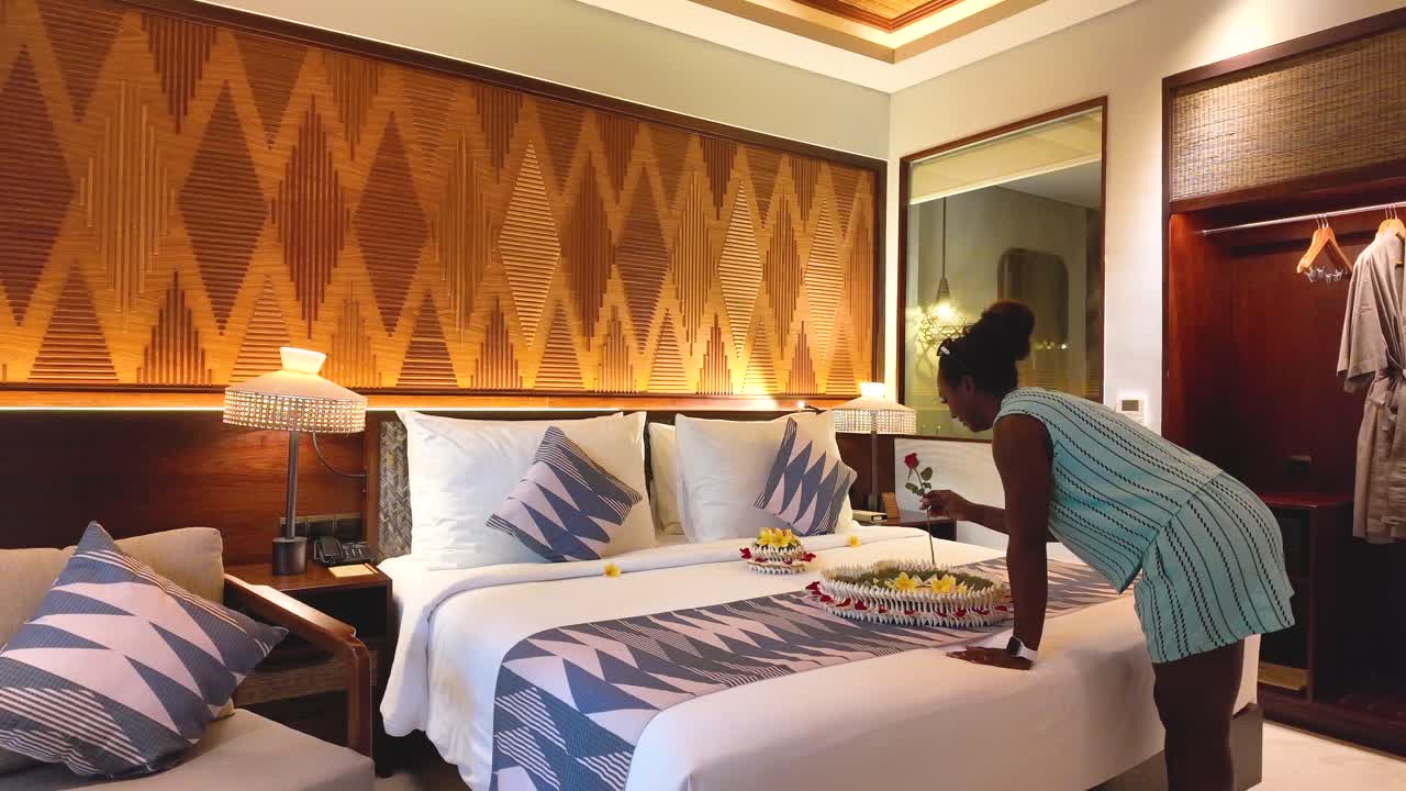 Black Female Tourist Discovering Romantic Honeymoon Bed and Reacting with Joy in Luxury Hotel Room, Ubud, Bali