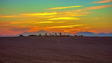 sunset time lapse - bedouin oasis in the harsh egyptian desert mountain landscape near hurghada