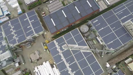 drone lifting up over industrial roof with solar panels