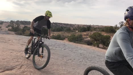 two athletic men mountain biking in the wilderness