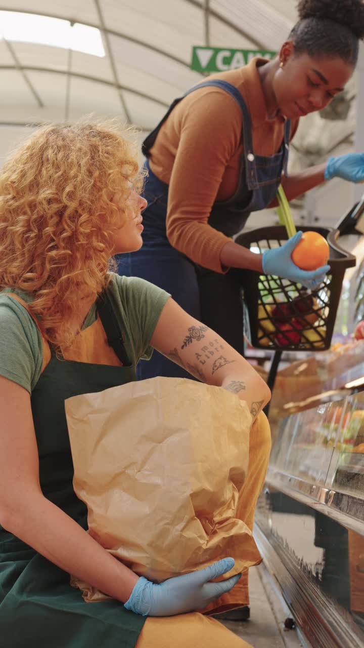 Two people buying produce at the store