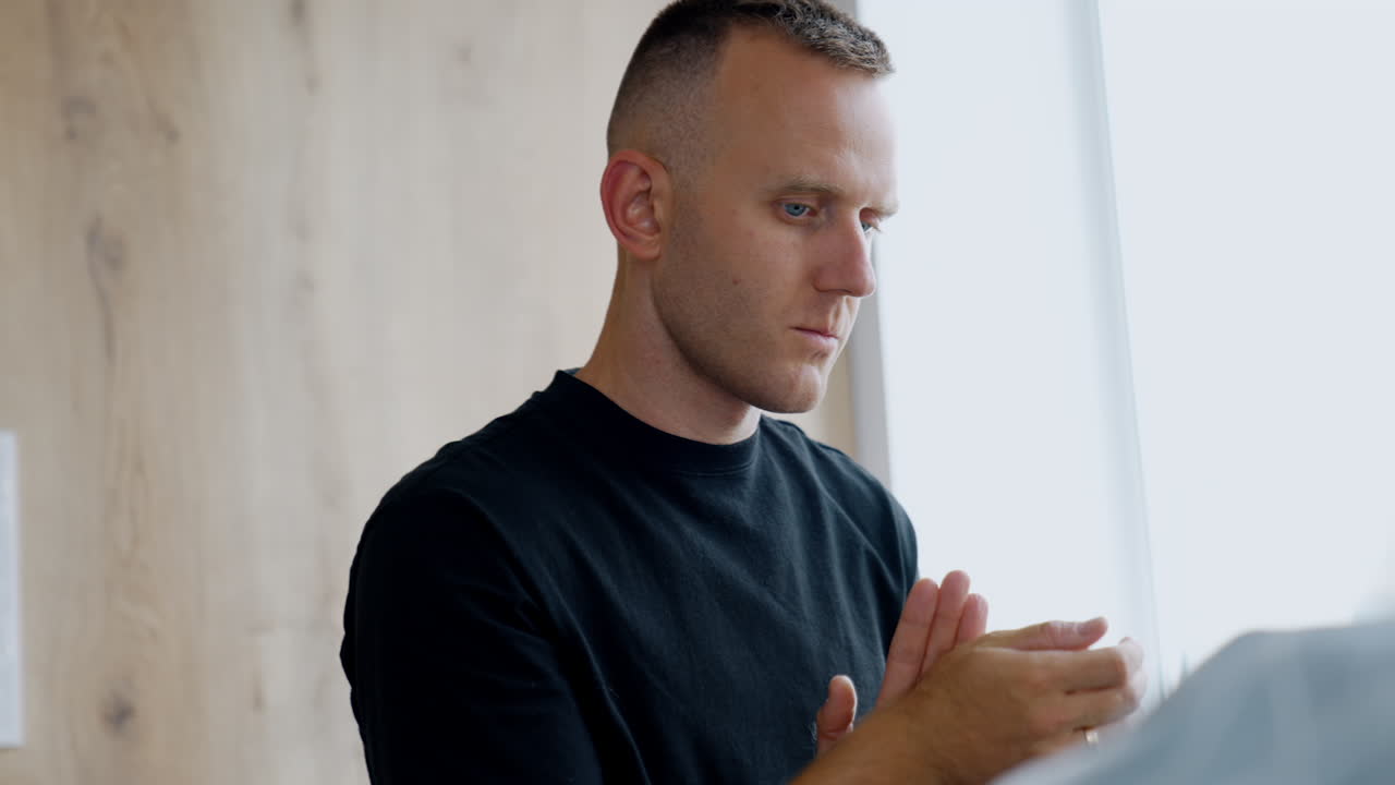 Concerned Caucasian man walking by the delivery room. Husband worries for his wife giving childbirth.